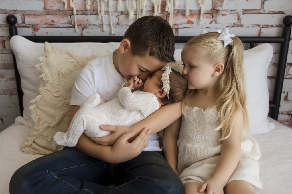 relaxed sibling photo with baby 